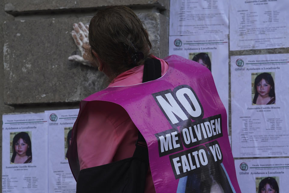 FILE - With a sign with the photo of a missing person with text that reads in Spanish "Do not forget me, I am missing" human rights activists and other relatives of missing persons protest in front of the Secretary of the Interior building in Mexico City, Monday, May 29, 2023. The Mexican government's 2023 bid to detect 'fake' missing people, those who have returned home but not notified authorities, has sparked anger among the families of Mexico's estimated 113,000 'disappeared.' (AP Photo/Marco Ugarte, File)