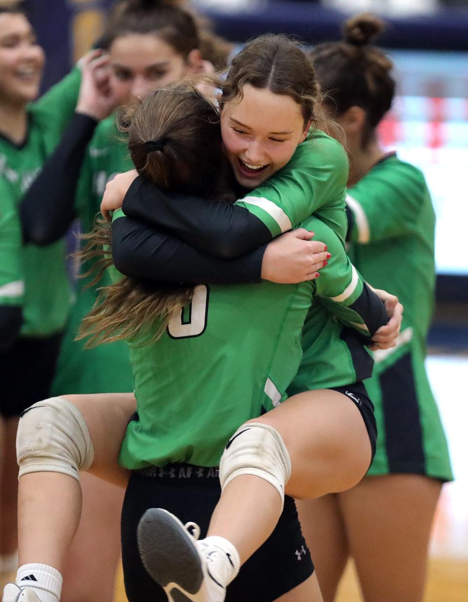 Highland's Kate Weber, facing, celebrates with Izzy Shank after beat Amherst in a Division I regional volleyball semifinal, Thursday, Nov. 3, 2022, in Norwalk, Ohio.