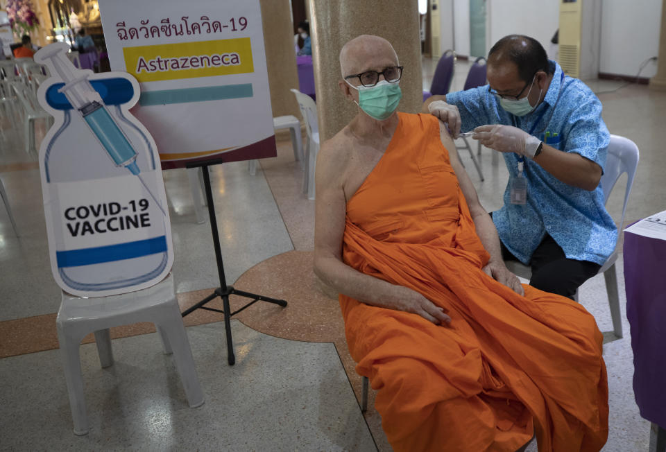 A health worker administers a dose of the AstraZeneca COVID-19 vaccine to a Buddhist monk at Nak Prok Temple in Bangkok, Thailand, Friday, April 9, 2021. (AP Photo/Sakchai Lalit)
