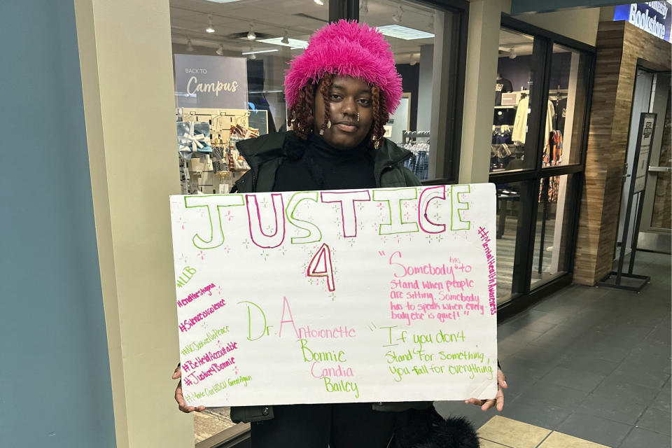 Cierra Tillman, a freshman computer information systems major at Lincoln University, holds up a sign calling for justice on Wednesday, Jan. 17, 2024, in Jefferson City, Mo., after the suicide of an administrator who alleged she was bullied. Antoinette Bonnie Candia-Bailey's death has spurred student protests at the idyllic red-brick campus in Jefferson City. President John Moseley agreed last week to go on paid leave pending a third-party investigation, but many of the school's 1,800 students and its alumni group are calling for his termination. (AP Photo/Summer Ballentine)