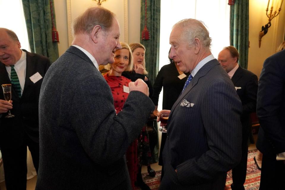 The King speaks to Michael Morpurgo at Clarence House (PA)