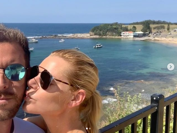 A photo of Sophie Monk kissing her boyfriend Joshua Gross on the cheek.