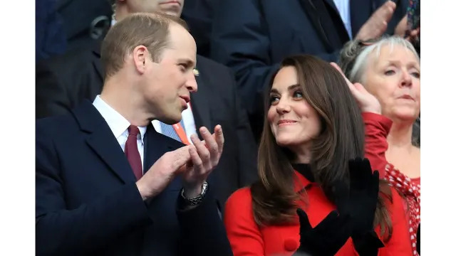 couple clapping at rugby match