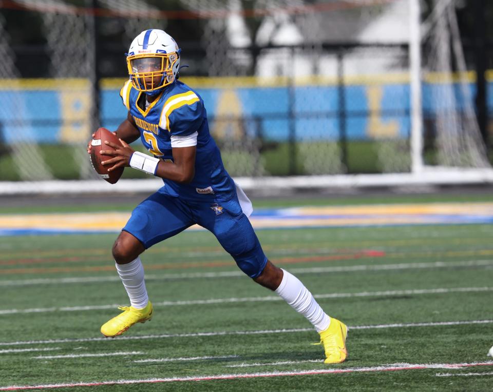 Irondequoit's Azavier Ross looks for an open player to throw to during their game against East High School at Irondequoit High School in Irondequoit, NY, September 10, 2022.  