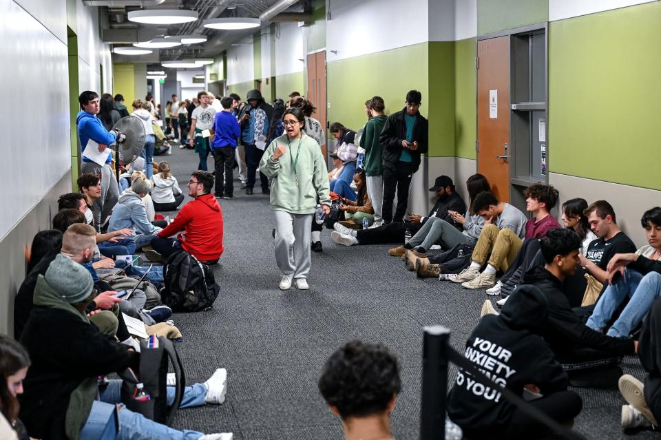 People wait in line to vote at the satellite office/polling location at Brody Hall after 9:30 p.m. on Tuesday, Nov. 8, 2022, on the Michigan State University campus in East Lansing. People in line before 8 p.m. were allowed to vote.