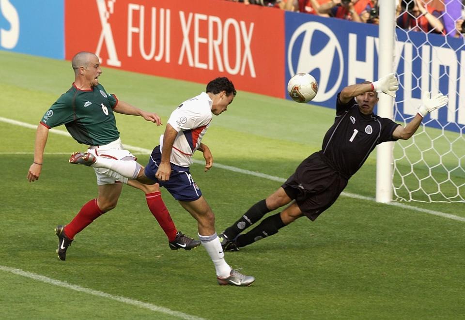 Landon Donovan scores the United States' second goal passed goalkeeper Oscar Perez of Mexico.