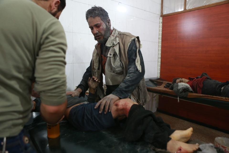 A Syrian man looks after his son, who is receiving treatment at a hospital after he was injured and his sister was killed in a reported airstrike in the rebel-controlled town of Hamouria, in the eastern Ghouta region on the outskirts of the capital Damascus, on Dec. 3, 2017. (Photo: Abudlmonam Eassa/AFP/Getty Images)