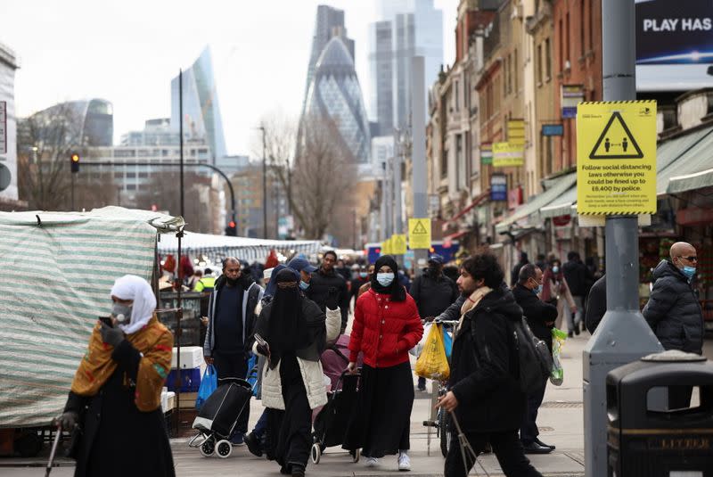 People walk past shops and market stalls, amid the coronavirus disease (COVID-19) outbreak in London