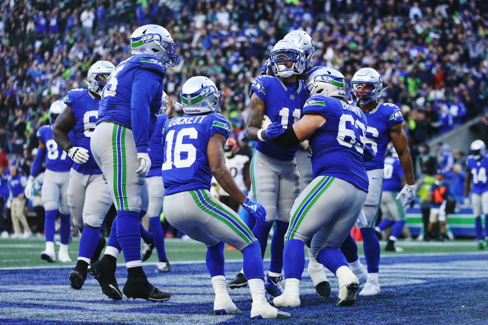 Seattle Seahawks wide receiver Jaxon Smith-Njigba, center, celebrates with teammates after scoring a touchdown late in the second half of an NFL football game against the Cleveland Browns, Sunday, Oct. 29, 2023, in Seattle. (AP Photo/Lindsey Wasson)