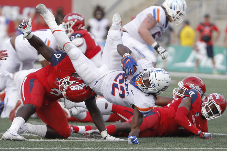 Fresno State’s Jeffrey Allison upends Boise State’s running back Alexander Mattison in Fresno, Calif., Saturday, Nov. 25, 2017. (AP Photo/Gary Kazanjian)