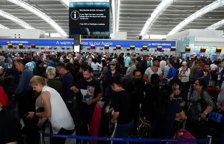 People wait with their luggage at the British Airways check in desks at Heathrow Terminal 5 in London, Britain May 28, 2017. REUTERS/Neil Hall