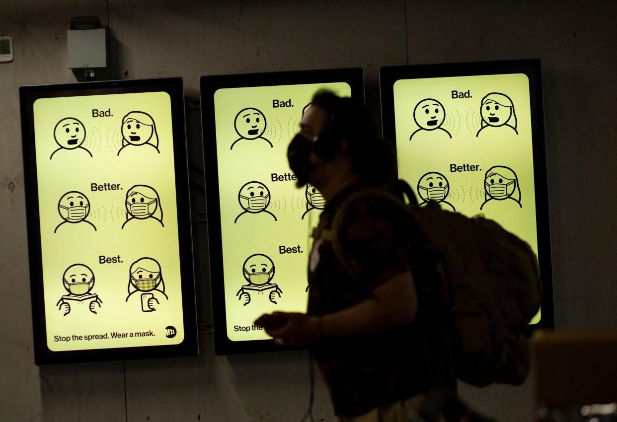 A sign displays mask-wearing information at Penn Station in New York in 2021.