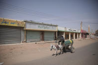 A man drives past shuttered shops after a military unseated the government earlier this week in Khartoum, Sudan, Thursday.. Oct 28, 2021. Gen Abdel-Fattah Buran dissolved the transitional government and detained the prime minister, many government officials and political leaders in a coup condemned by the U.S. and the West. The military allowed Hamdok to return home Tuesday after international pressure for his release. (AP Photo/Marwan Ali)