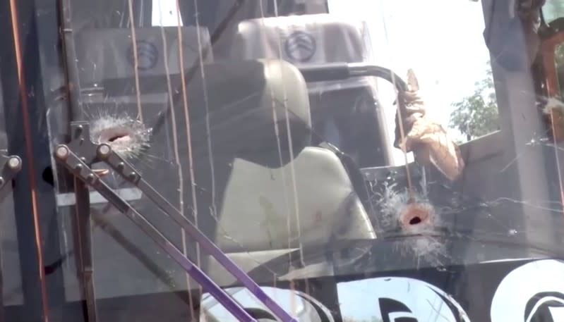 Bullet holes in a bus window are seen after it was attacked near Fada N'gourma