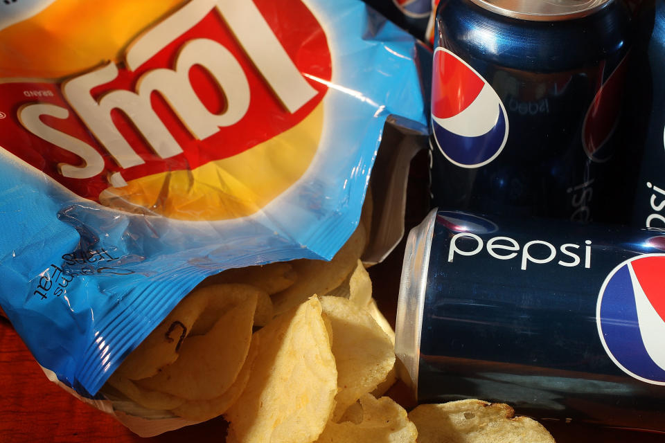 MIAMI - MARCH 22:  In this photo illustration a bag of chips maufactured by PepsiCo's Frito-Lay brand and cans of their Pepsi soda is seen on March 22, 2010 in Miami, Florida.  PepsiCo announced plans to cut sugar, fat, and sodium in its products to address health and nutrition concerns. The maker of soft drinks including Pepsi-Cola, Gatorade also makes Frito-Lay brand snacks.  (Photo Illustration by Joe Raedle/Getty Images)
