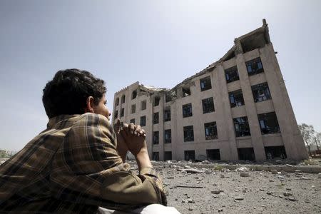 A Houthi militant sits amidst debris from the Yemeni Football Association building, which was damaged in a Saudi-led air strike, in Sanaa May 31, 2015. REUTERS/Mohamed al-Sayaghi