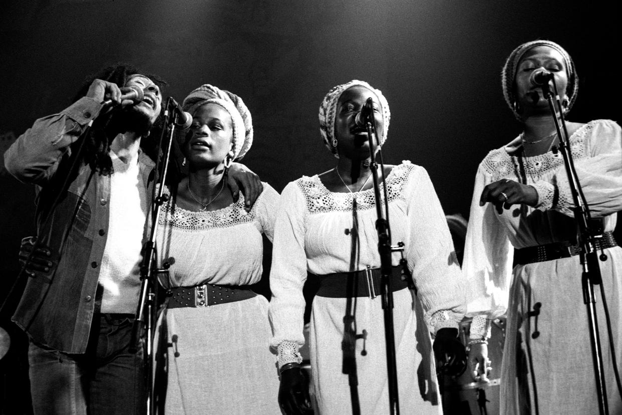 Bob Marley performing with  Judy Mowatt, Rita Marley, and Marcia Griffiths of the I Threes in 1977.
