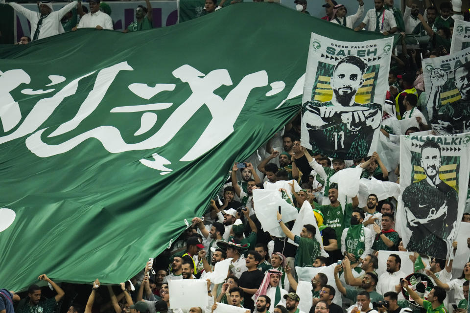 Saudi Arabian fans cheer before the World Cup group C soccer match between Saudi Arabia and Mexico, at the Lusail Stadium in Lusail, Qatar, Wednesday, Nov. 30, 2022. (AP Photo/Julio Cortez)