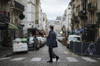 A man wearing a mask, walks in the Montmartre district of Paris, Sunday, Oct.25, 2020. A curfew intended to curb the spiraling spread of the coronavirus, has been imposed in many regions of France including Paris and its suburbs. (AP Photo/Lewis Joly)