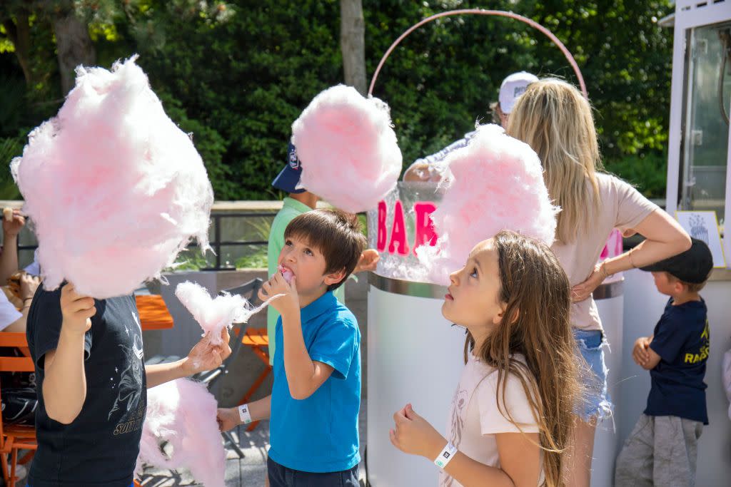 june holidays children eating cotton candy for national children's day