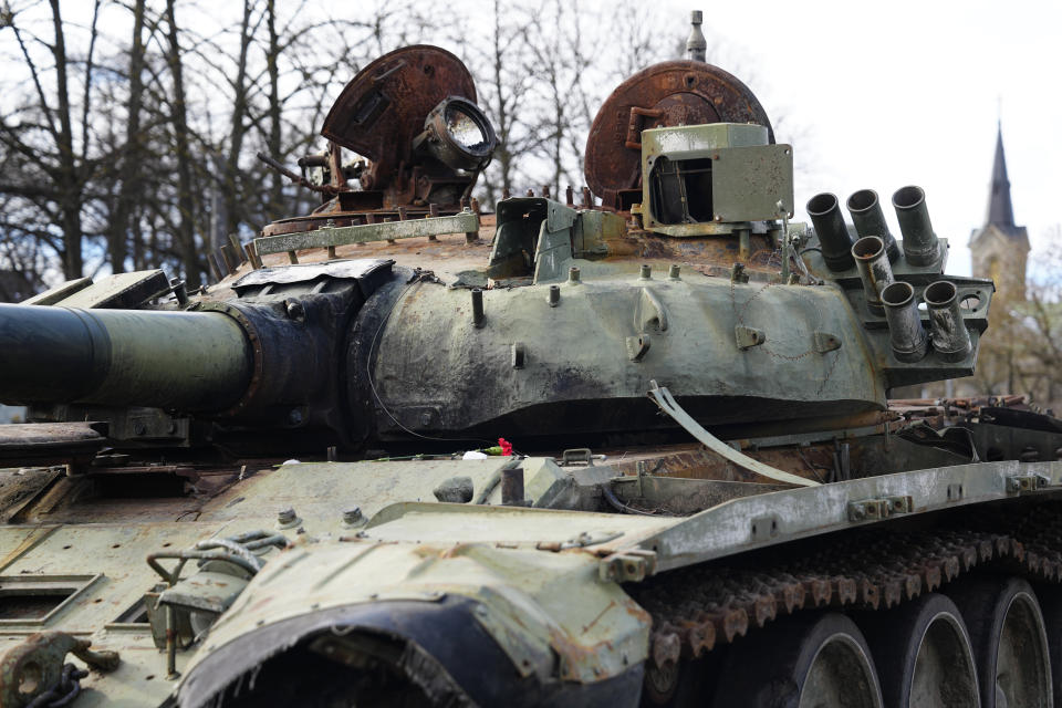A flower is placed on a destroyed Russian T-72B3 tank installed as a symbol of the Russia Ukraine war to mark the first anniversary of Russia's full-scale invasion of Ukraine, in Freedom Square in Tallinn, Estonia, Wednesday, March 1, 2023. (AP Photo/Pavel Golovkin)