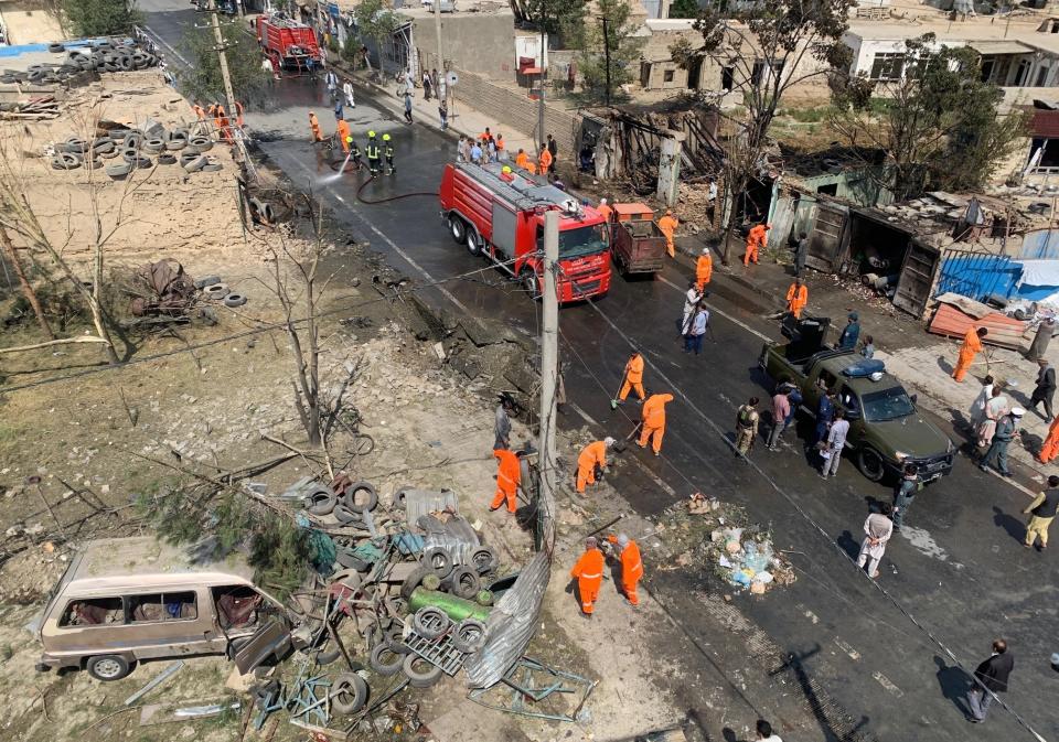 Afghan security personnel and Municipality workers clean at the site of an explosion in Kabul, Afghanistan, Wednesday, Sept. 9, 2020. Spokesman for Afghanistan's Interior Ministry said the bombing that targeted the convoy of the country's first vice president on Wednesday morning killed several people and wounded more than a dozen others, including several of the vice president's bodyguards.(AP Photo/Rahmat Gul)