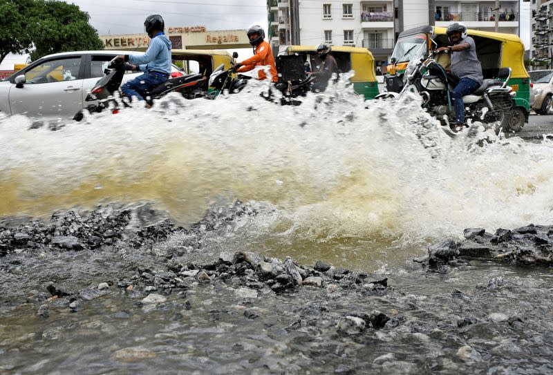 FILE PHOTO: Traffic moves as water is pumped out of an inundated residential area following torrential rains in Bengaluru