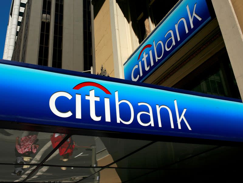 FILE PHOTO: People walk beneath a Citibank branch logo in the financial district of San Francisco, California