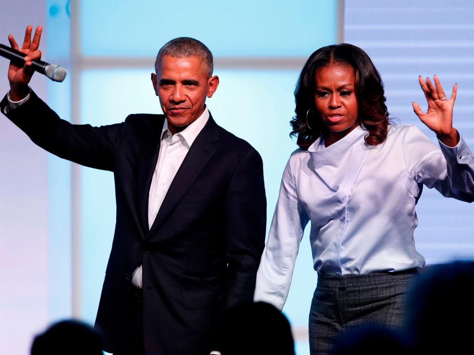 Barack and Michelle Obama waving