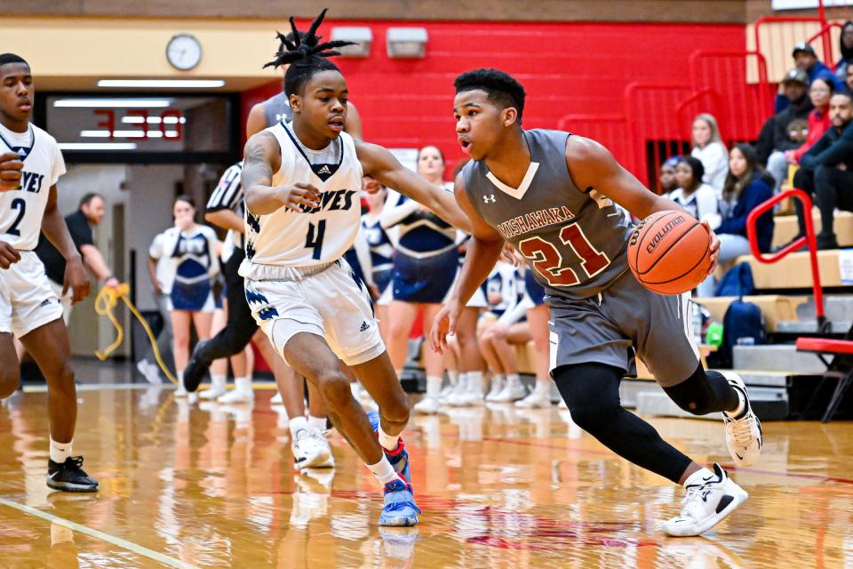 Mishawaka's Arthur Jones (21) drives to the basket as Michigan City's Kanye Roberson (4) defends in the second half Tuesday, March 1, 2022, at Plymouth High School.