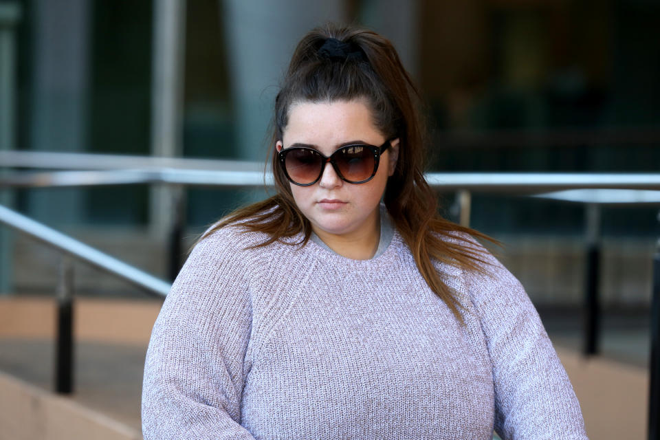 Woman pictured outside court where she faced animal cruelty charges for starving a dog.