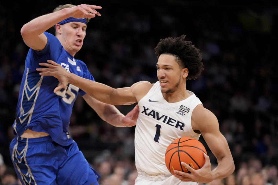 Xavier's Desmond Claude (1) drives against Creighton's Baylor Scheierman (55) in the first half of an NCAA college basketball game during the semifinals of the Big East conference tournament, Friday, March 10, 2023, in New York. (AP Photo/John Minchillo)