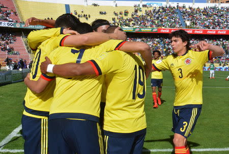 Football Soccer - Bolivia v Colombia - World Cup Qualifiers - Hernando Siles stadium-La Paz, Bolivia 24/3/16. Colombia's James Rodriguez (L) celebrates with teammates after scoring. REUTERS/Alejandro Alvarez