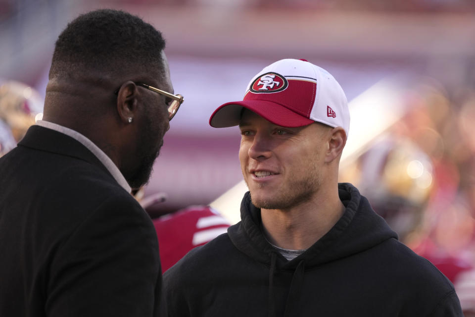 Former running back Ricky Watters, left, talks with San Francisco 49ers running back Christian McCaffrey during an NFL football game between the 49ers and the Los Angeles Rams in Santa Clara, Calif., Sunday, Jan. 7, 2024. (AP Photo/Loren Elliott)