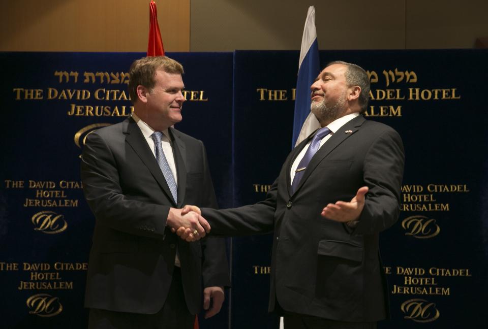 Israel's Foreign Minister Lieberman greets his Canadian counterpart Baird before their dinner in Jerusalem