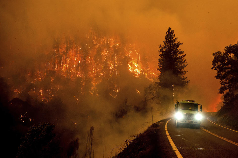 A firetruck drives along California Highway 96 as the McKinney Fire burns in Klamath National Forest, Calif., Saturday, July 30, 2022. (AP Photo/Noah Berger)