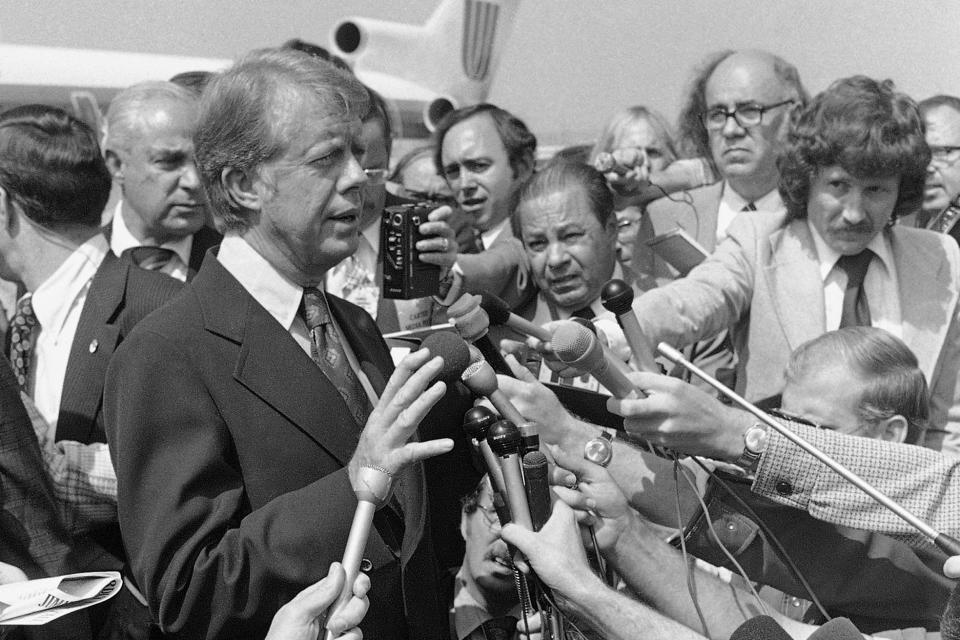FILE - Democratic presidential nominee Jimmy Carter speaks to reporters on his arrival at Hobby International Airport in Houston on Friday, Sept. 24, 1976. He explained how his remarks in a Playboy magazine interview about the late President Lyndon Johnson were misinterpreted, and that he did not mean to put Johnson and Richard Nixon in the same class. (AP Photo/Jack Thornell, File)