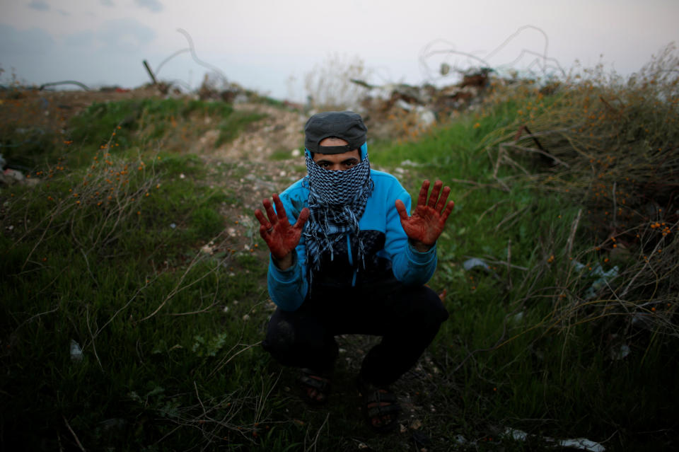 <p>A Palestinian protester, nicknamed Abu Jaber, gestures with his hands stained with the blood of a wounded friend as he poses for a photograph at the scene of clashes with Israeli troops near the border with Israel, east of Gaza City, Jan. 19, 2018. “We protest against the crazy decision made by Trump on Jerusalem and against the hardship we have experienced for more than 10 years due to the Israeli blockade. I hope the blood which you can see on my hands will move the Arab and Muslim world to revolt against Israel and America,” said Abu Jaber. (Photo: Mohammed Salem/Reuters) </p>