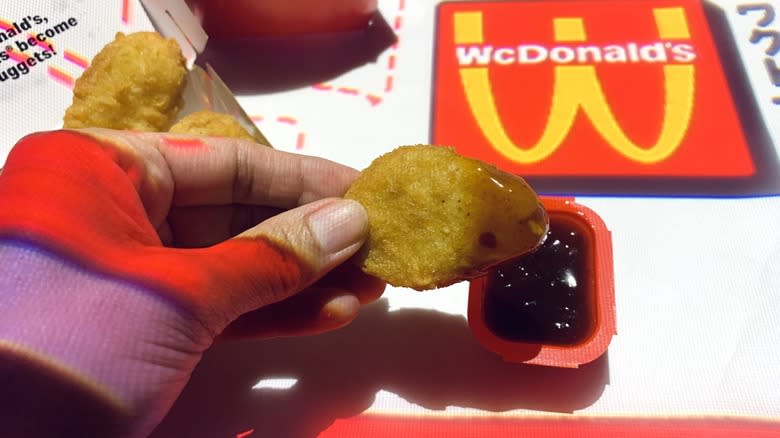 dipping mcnuggets in chili sauce