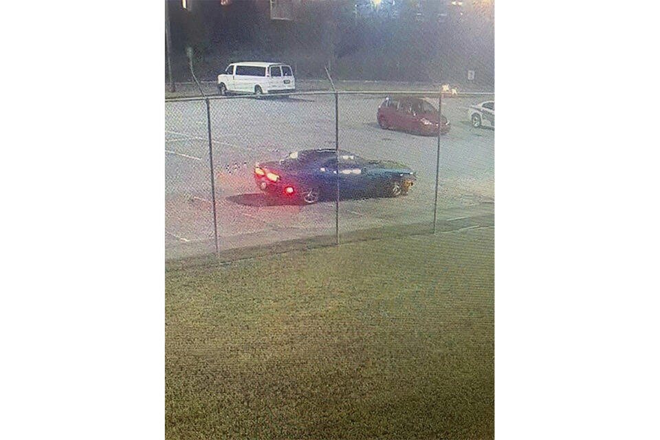 This image provided by the Bibb County, Ga., Sheriff’s Office shows a blue Dodge Challenger outside of a central Georgia jail. Authorities are looking to talk to the driver of the vehicle for possible involvement in the escape. (Bibb County Sheriff’s Office via AP)