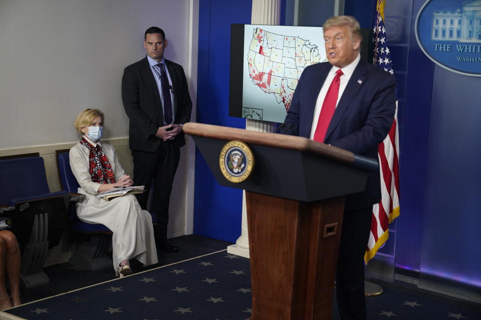 White House coronavirus response coordinator Dr. Deborah Birx, left, listens as President Donald Trump speaks during a news conference at the White House, Thursday, July 23, 2020, in Washington. (AP Photo/Evan Vucci)