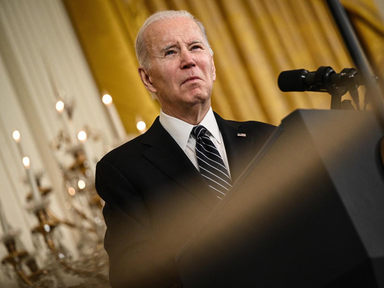 President Joe Biden standing at a podium.