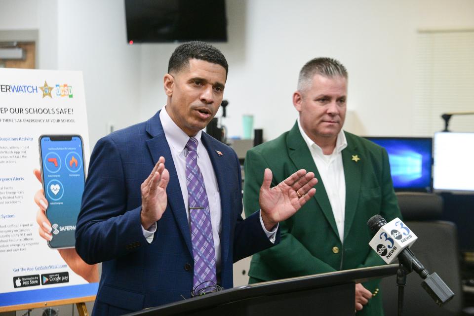 Marcus Chambers, superintendent of the Okaloosa County School District, talks to reporters Wednesday about SaferWatch, a new emergency communications program that has been implemented in Okaloosa County schools since October. SaferWatch is a phone-based app that allows school teachers, administrators and staff to access a quick alert system linked directly to the Okaloosa County Sheriff's Office's 911 Communications Center. At right is Okaloosa County Sheriff Eric Aden, who spoke about the new program from a law enforcement perspective.