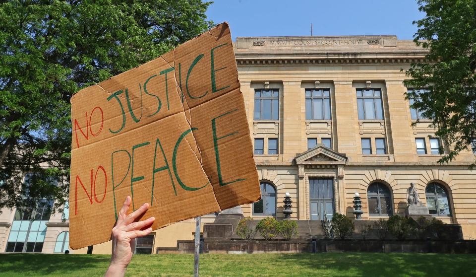 Protesters pass the Summit County Courthouse, where a special grand jury decided to not indict the Akron police officers who killed Jayland Walker last summer, during a Justice for Jayland National March on May 24.