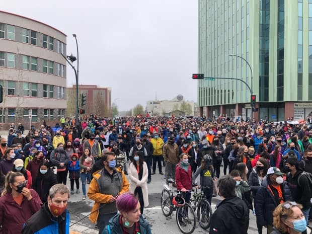 Hundreds took to the streets of Yellowknife on Friday to honour the 215 children whose remains were found at the site of a former residential school in Kamloops, British Columbia. (Avery Zingel/CBC - image credit)