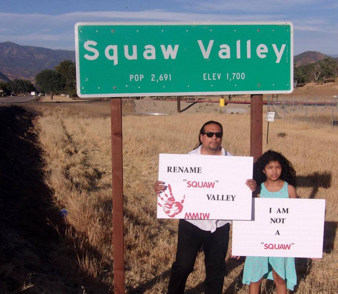 Roman Rain Tree with his 10-year-old daughter, Lola, in front of the town sign for Squaw Valley in Fresno County, California.