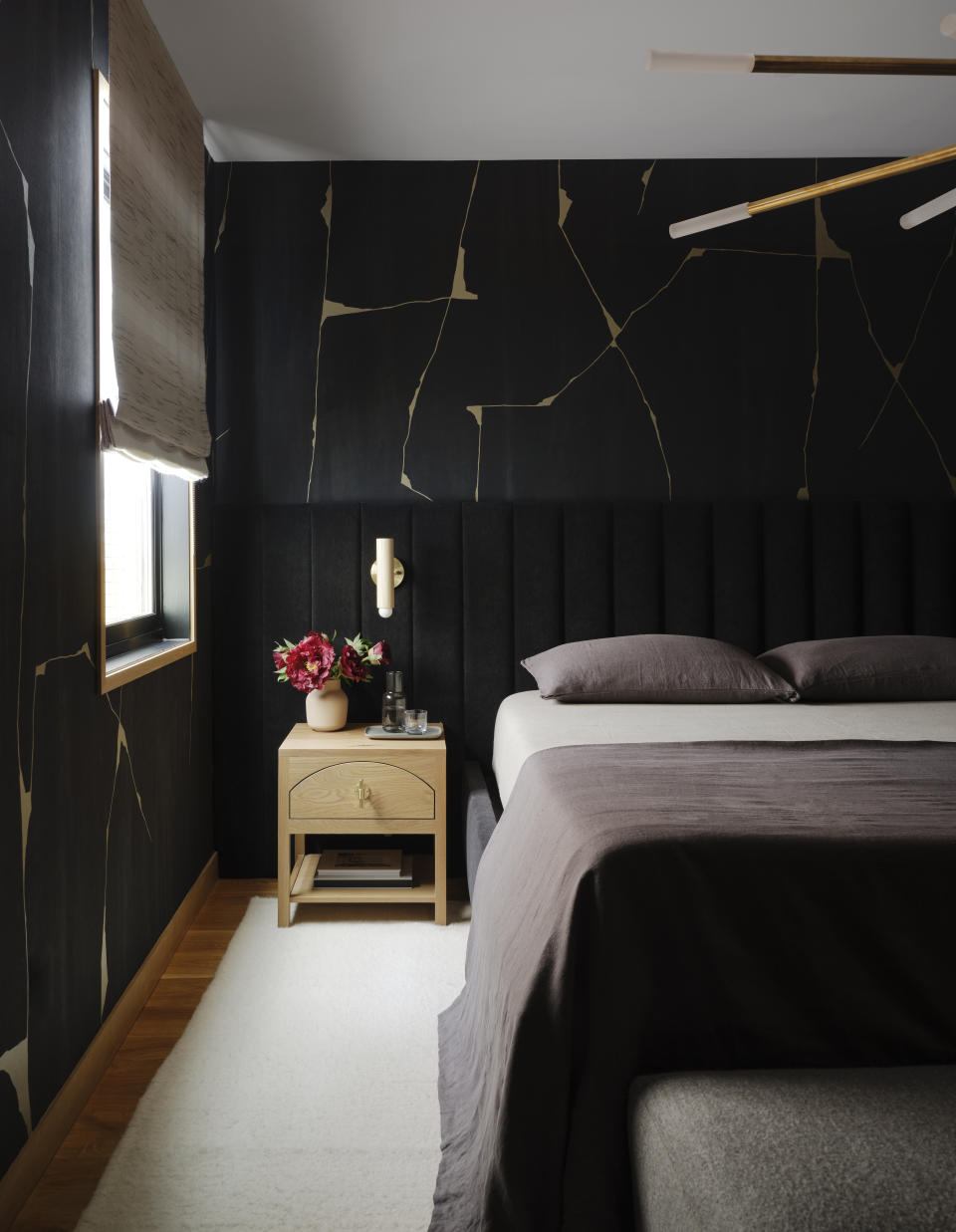 A small bedroom with dark walls