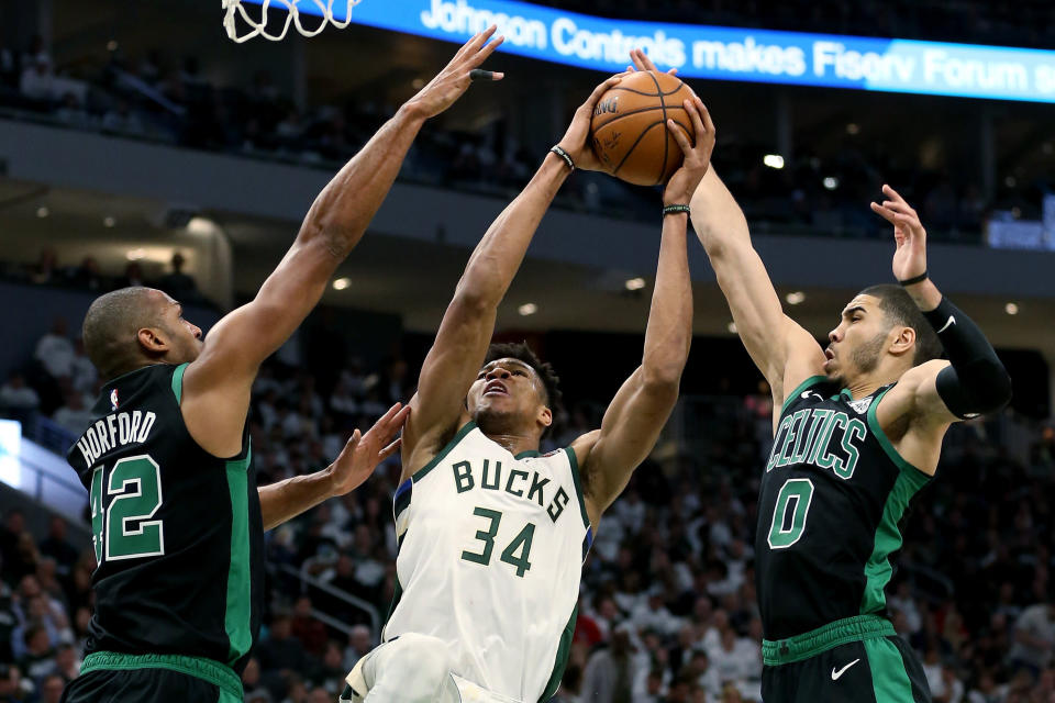 MILWAUKEE, WISCONSIN - APRIL 28:  Giannis Antetokounmpo #34 of the Milwaukee Bucks attempts a shot while being guarded by Al Horford #42 and Jayson Tatum #0 of the Boston Celtics in the third quarter during Game One of Round Two of the 2019 NBA Playoffs at the Fiserv Forum on April 28, 2019 in Milwaukee, Wisconsin. NOTE TO USER: User expressly acknowledges and agrees that, by downloading and or using this photograph, User is consenting to the terms and conditions of the Getty Images License Agreement. (Photo by Dylan Buell/Getty Images)