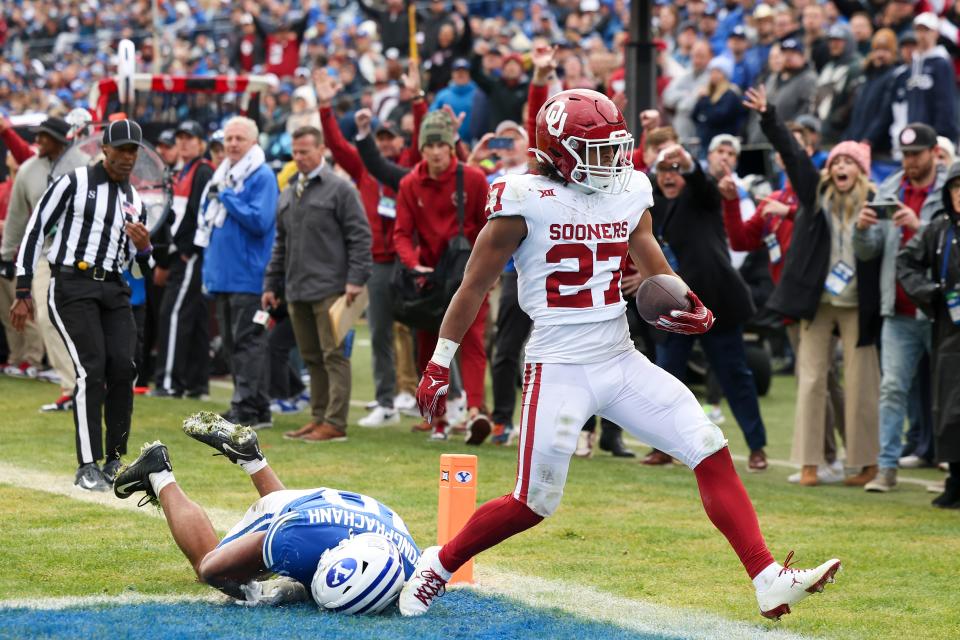 OU running back Gavin Sawchuk (27) scores a touchdown past BYU linebacker AJ Vongphachanh (10) last season at LaVell Edwards Stadium in Provo, Utah.