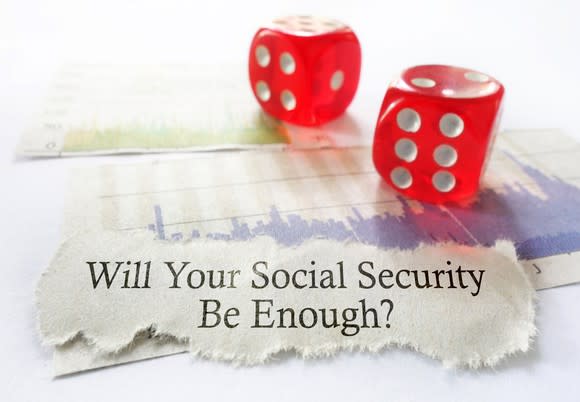 Two red dice next to torn piece of paper on which is printed "Will Your Social Security Be Enough?"